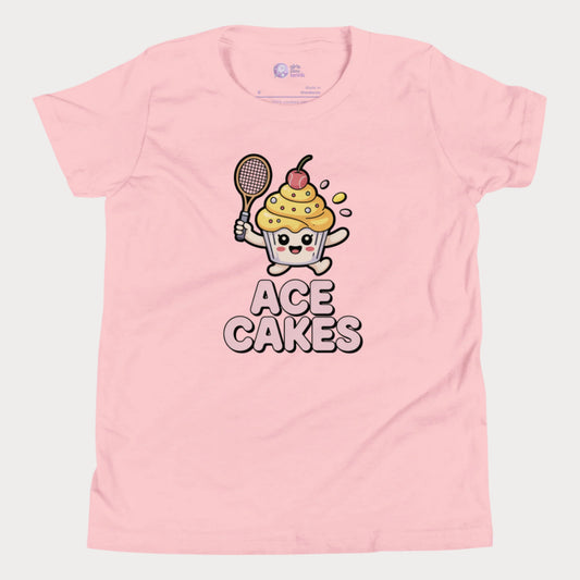 Pink girls tennis t-shirt with a cartoon cupcake character holding a tennis racket and the text 'ACE CAKES' on a white background.