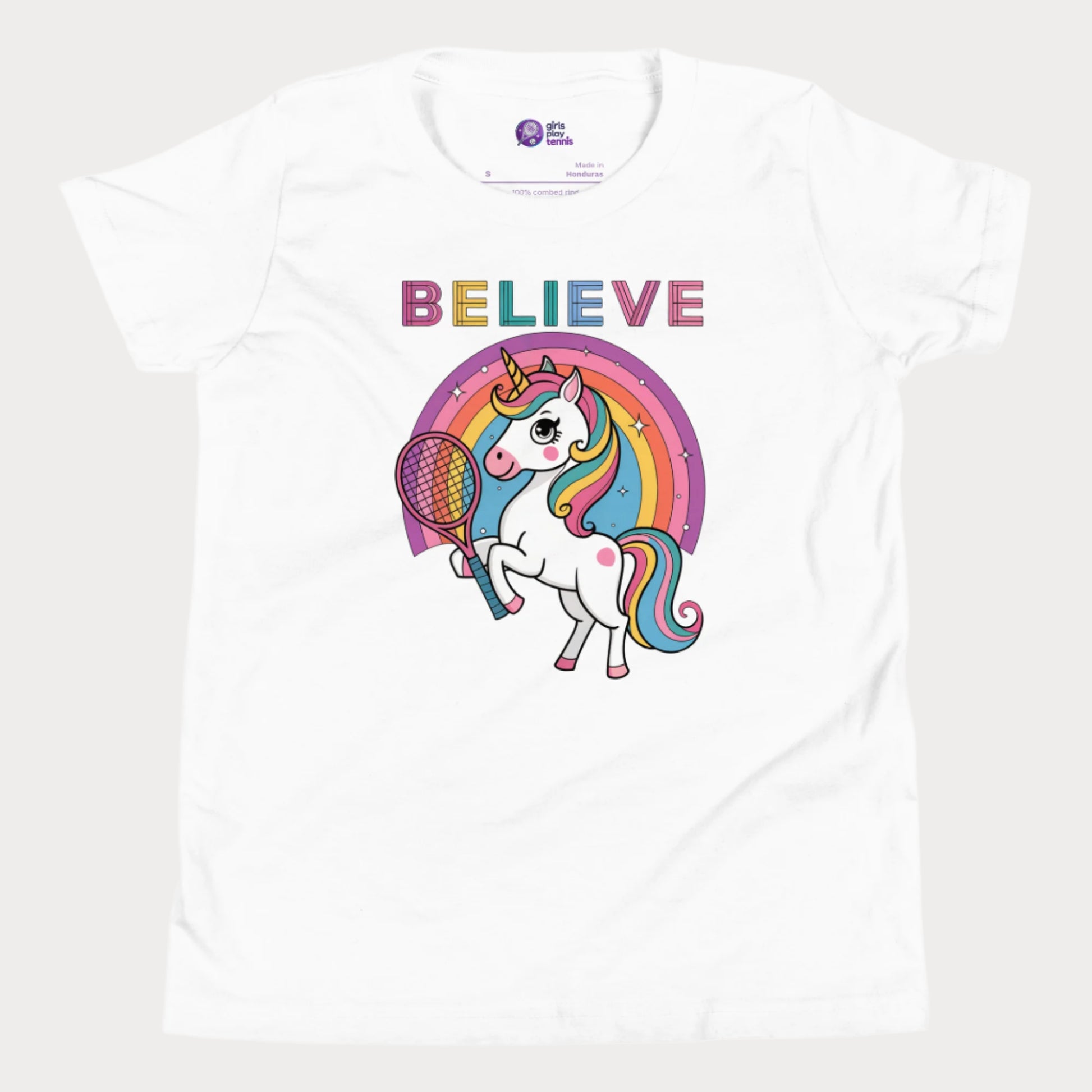 Cute white girls' tennis t-shirt featuring a magical unicorn holding a tennis racket with a colorful rainbow backdrop. Perfect for young girls who love tennis, unicorns, and stylish sportswear.