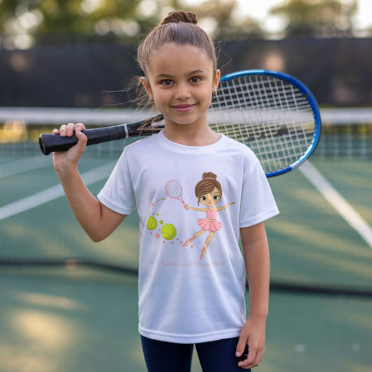 Young girl standing on a tennis court, holding a tennis racket and wearing an adorable girls' tennis t-shirt featuring a ballerina in a pink tutu gracefully swinging a tennis racket, with stars and tennis balls trailing behind.