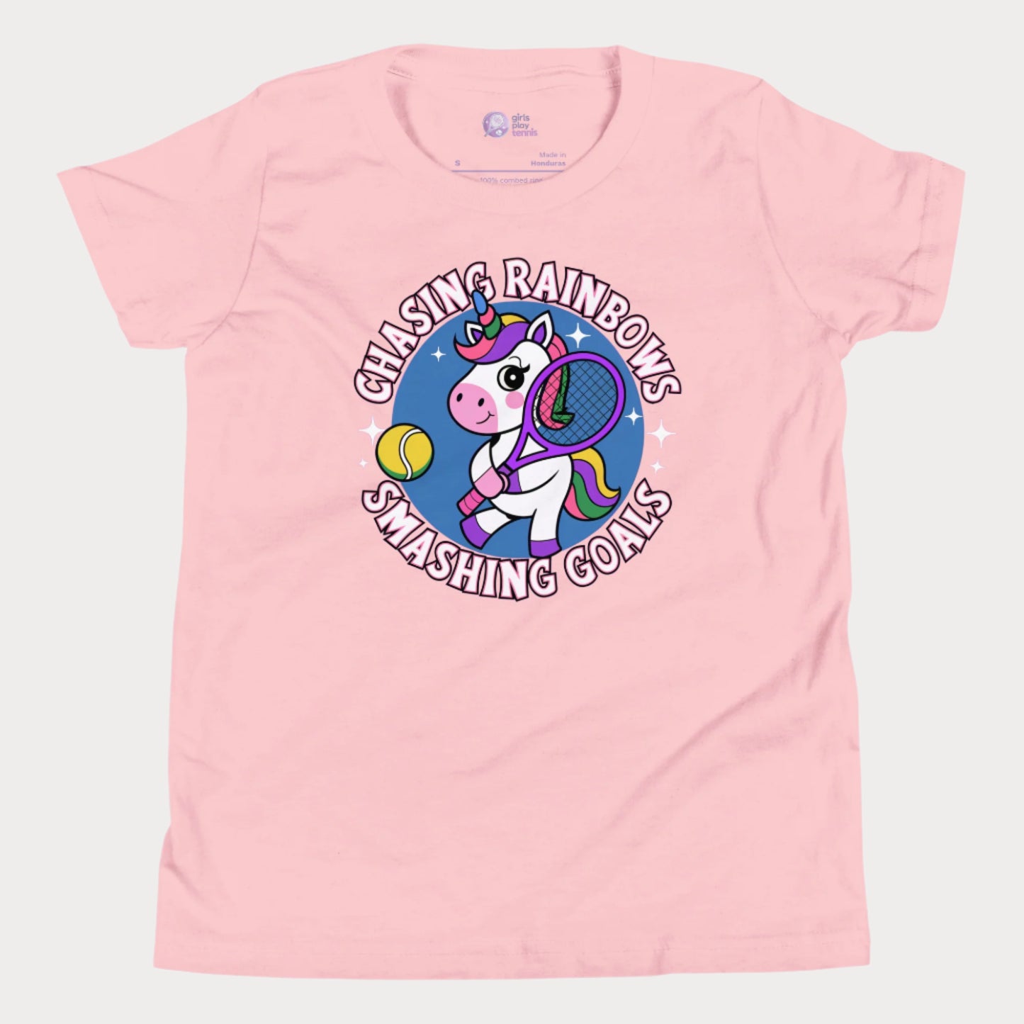 Pink girls' tennis t-shirt featuring a fun and colorful unicorn holding a tennis racket, with the motivational slogan "Chasing Rainbows, Smashing Goals."