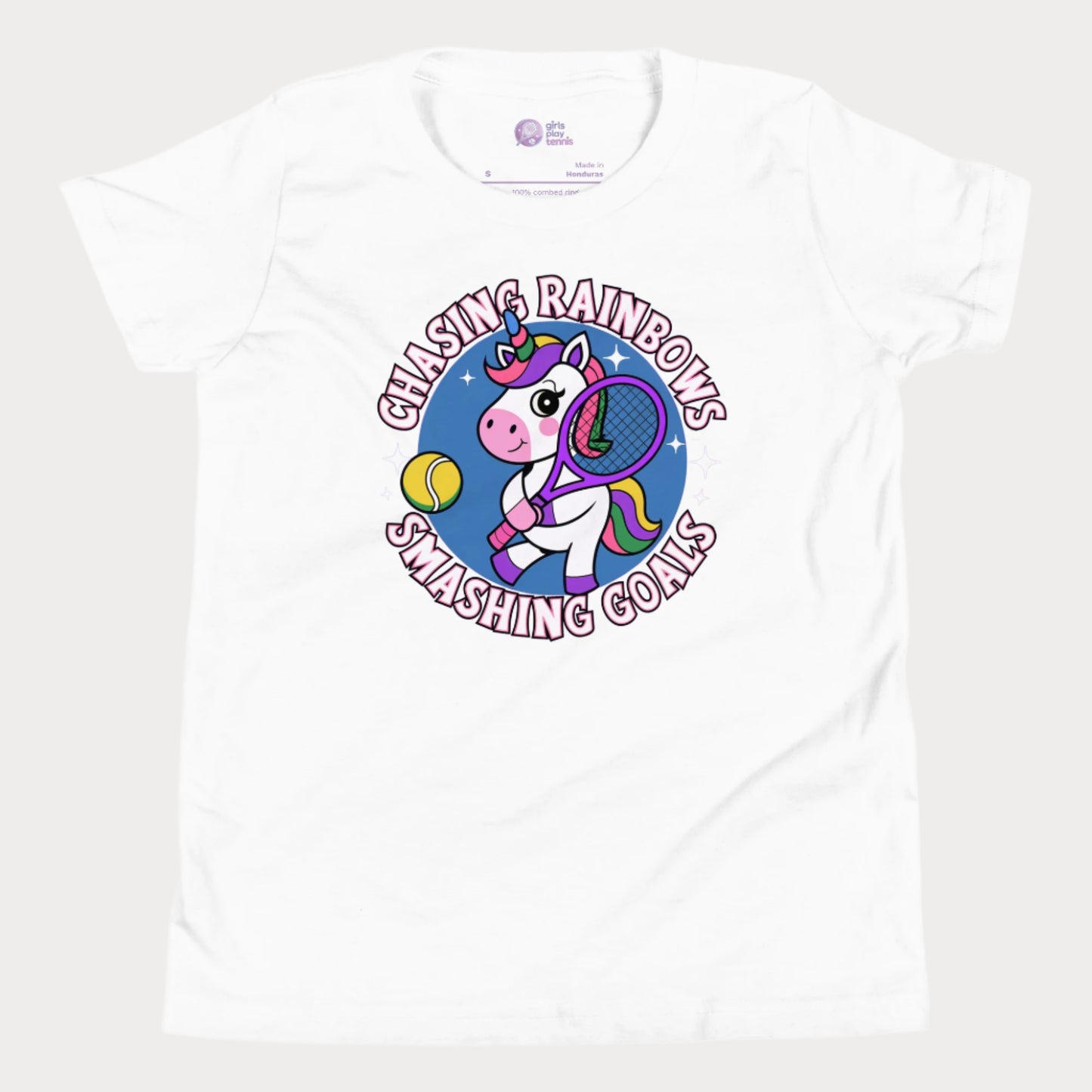 White girls' tennis t-shirt featuring a fun and colorful unicorn holding a tennis racket, with the motivational slogan "Chasing Rainbows, Smashing Goals."