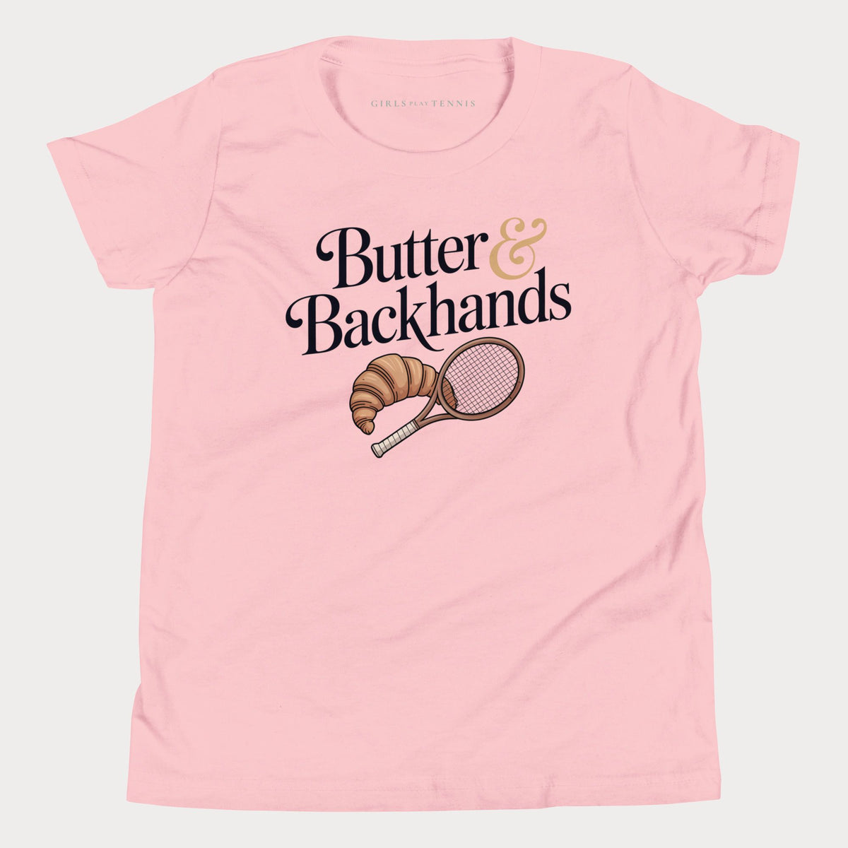 Pink Butter & Backhands girls' tennis T-shirt with a croissant and tennis racket graphic