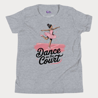 A stylish grey girls' tennis t-shirt featuring a graceful young ballerina in a pink tutu performing an elegant pose on a tennis court. The text 'Dance on the Court' blends ballet and tennis, celebrating the fluid movement and grace of the game. Designed for young girls who love tennis and fashion, this Girls Play Tennis apparel piece adds a fun, feminine twist to the sport.