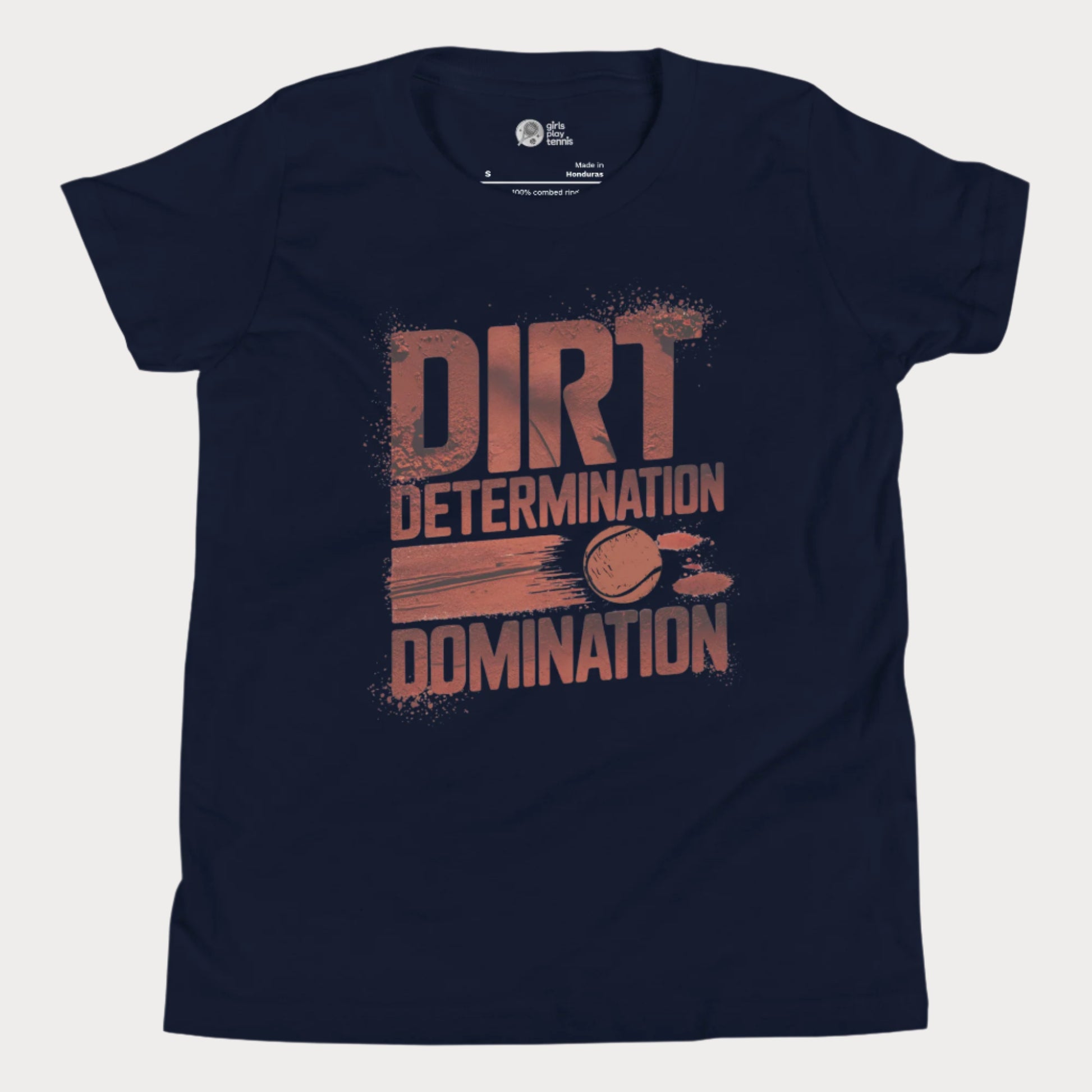 Navy tennis T-shirt featuring bold typography reading "Dirt, Determination, Domination" in clay-red tones, with a graphic of a tennis ball streaking across the design.