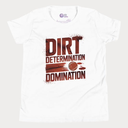 White girls' tennis T-shirt featuring bold typography reading "Dirt, Determination, Domination" in clay-red tones, with a graphic of a tennis ball streaking across the design.