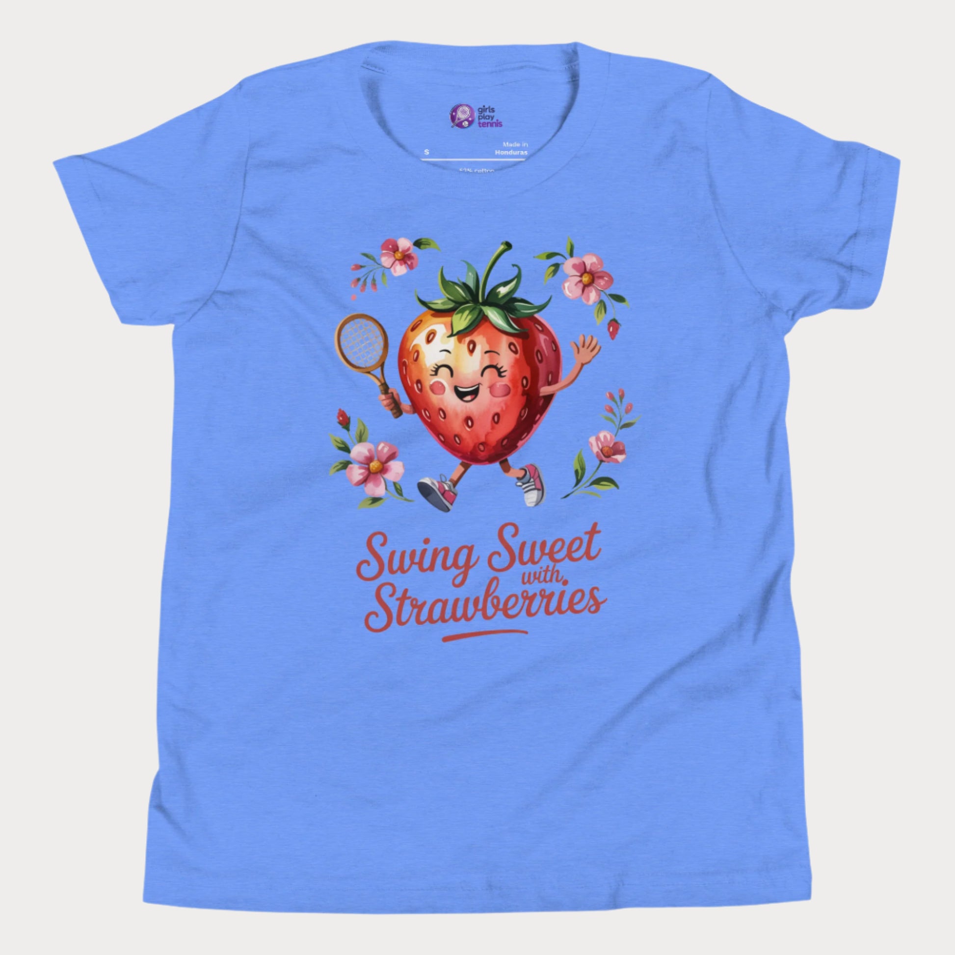 Blue girls tennis t-shirt with a smiling strawberry holding a tennis racket surrounded by pink flowers and the phrase ‘Swing Sweet with Strawberries’