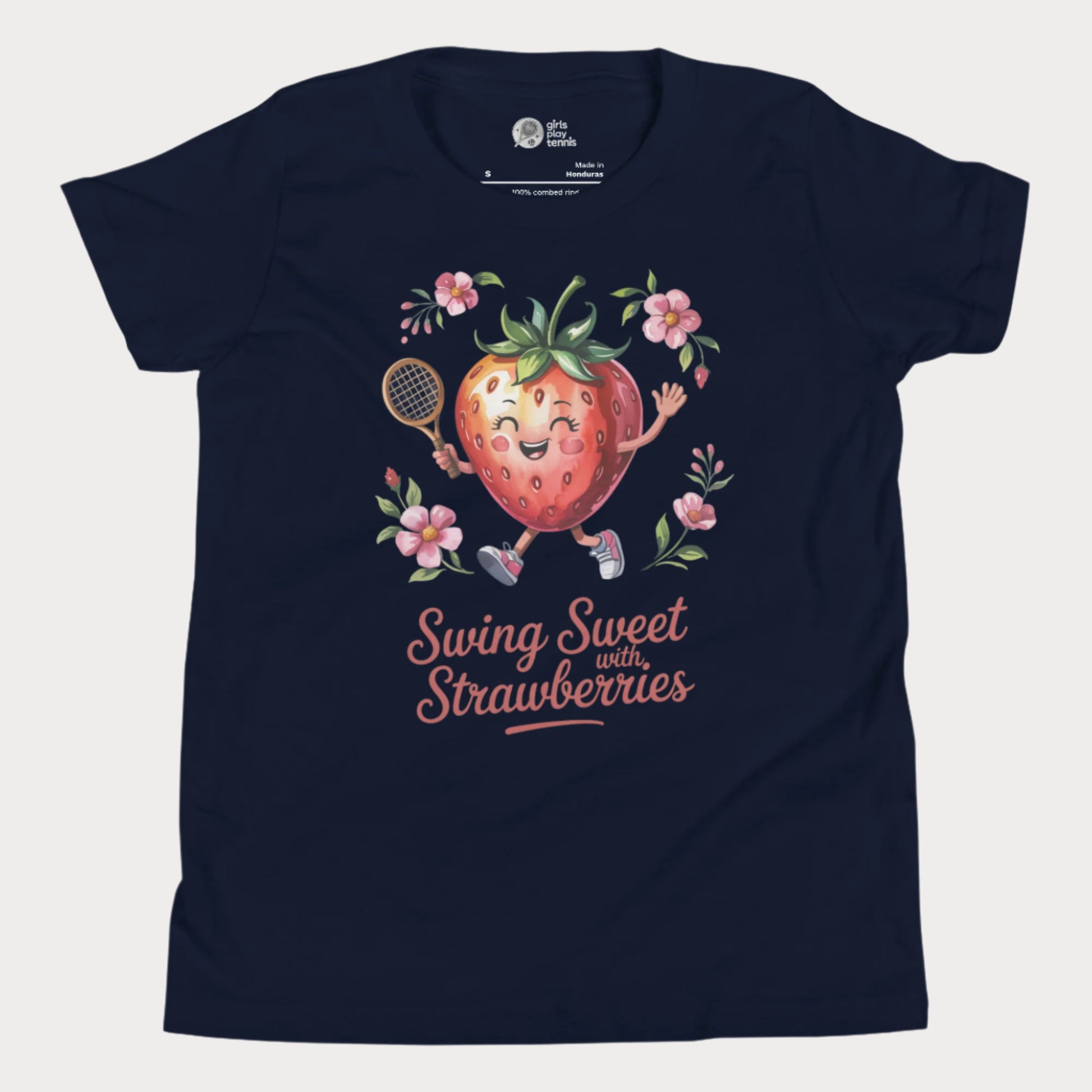 Navy girls tennis t-shirt with a smiling strawberry holding a tennis racket surrounded by pink flowers and the phrase ‘Swing Sweet with Strawberries’