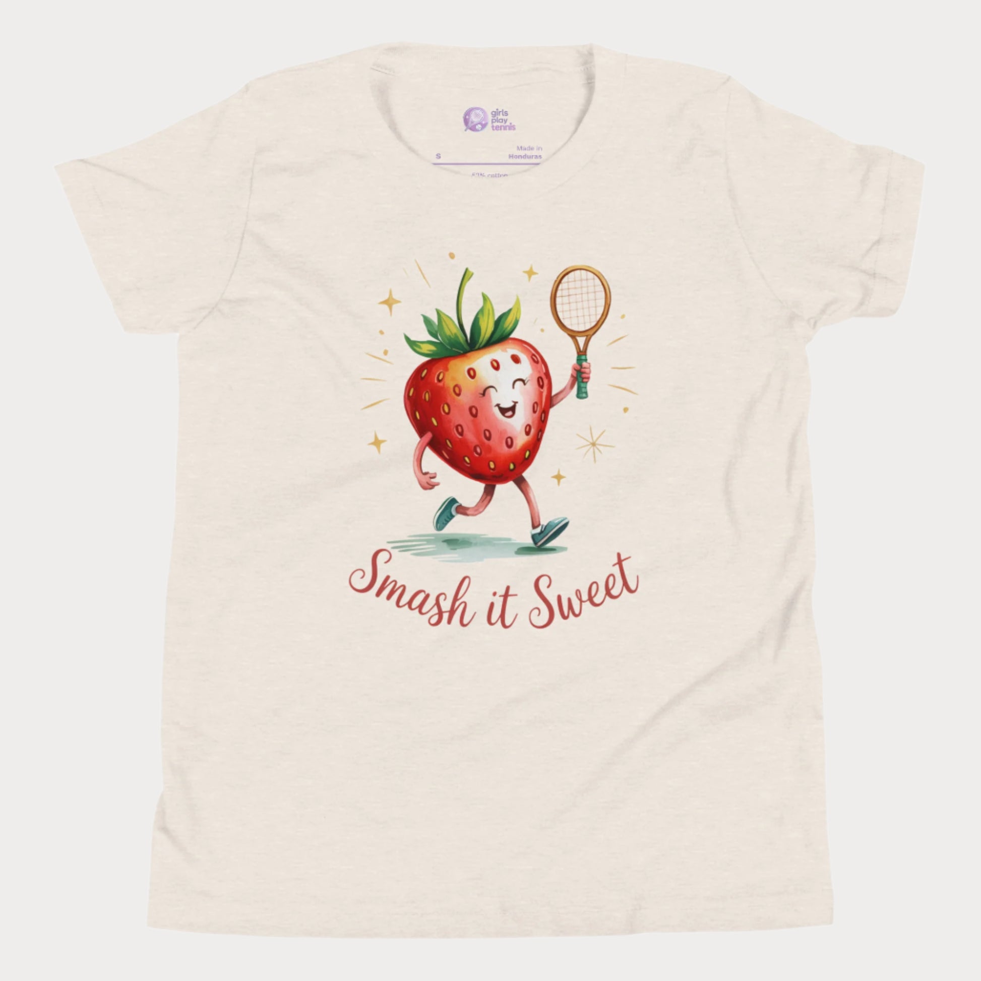 Beige girls tennis t-shirt with cartoon strawberry holding tennis racket and “Smash it Sweet” slogan
