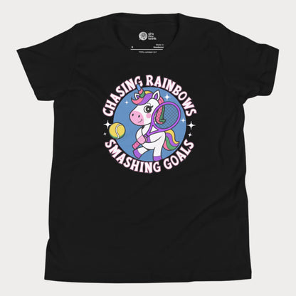 Black girls' tennis t-shirt featuring a fun and colorful unicorn holding a tennis racket, with the motivational slogan "Chasing Rainbows, Smashing Goals."