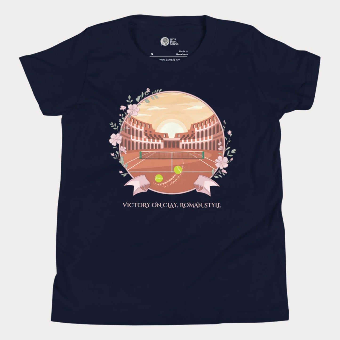 Navy blue girls' tennis T-shirt featuring a clay court set inside an ancient Roman amphitheater, surrounded by floral accents and a banner reading "Victory on Clay, Roman Style."