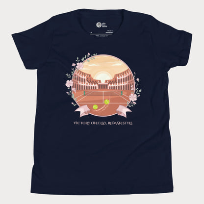 Navy blue girls' tennis T-shirt featuring a clay court set inside an ancient Roman amphitheater, surrounded by floral accents and a banner reading "Victory on Clay, Roman Style."