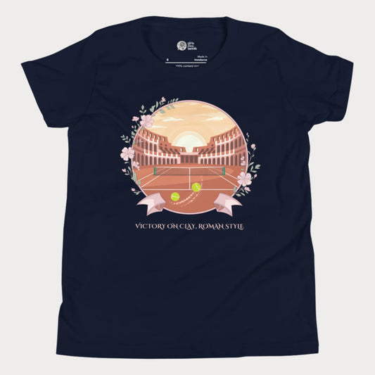 Navy blue girls' tennis T-shirt featuring a clay court set inside an ancient Roman amphitheater, surrounded by floral accents and a banner reading "Victory on Clay, Roman Style."