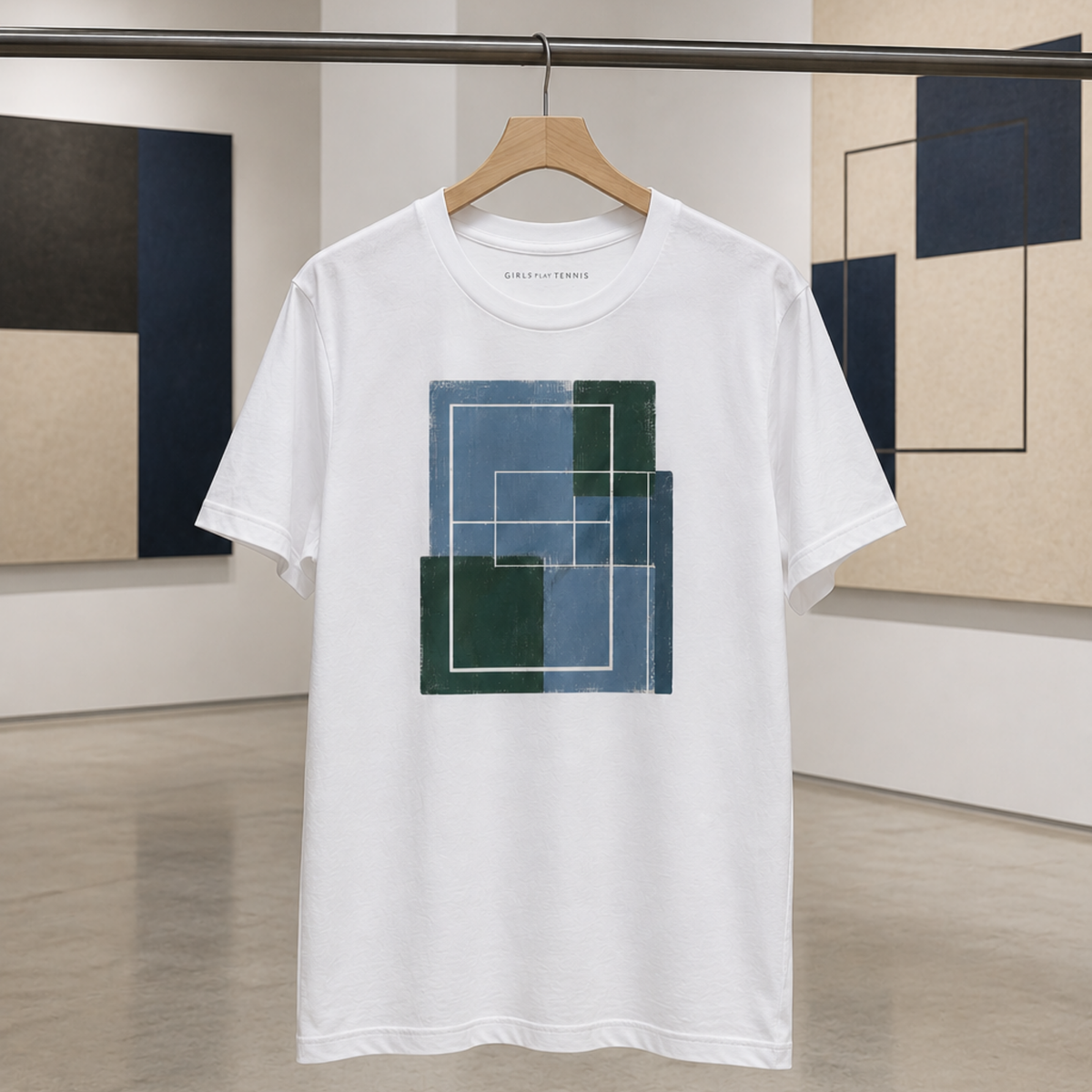 White Hard Court Study No. 3 tee on a hanger in a gallery, in front of abstract paintings