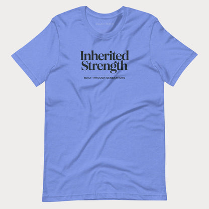 A light blue crewneck t-shirt with 'Inherited Strength' printed in black serif font on the chest, accompanied by the smaller text 'BUILT THROUGH GENERATIONS' underneath, displayed on a light gray background.
