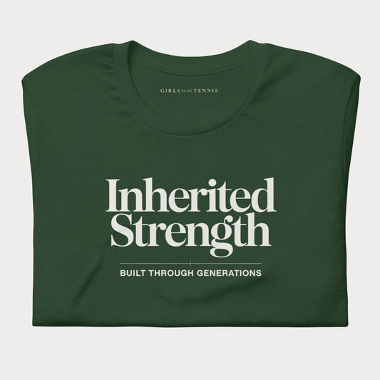 A dark green folded short-sleeve women's tennis t-shirt with white text reading 'Inherited Strength' and 'BUILT THROUGH GENERATIONS' on the front, shown on a light gray background.