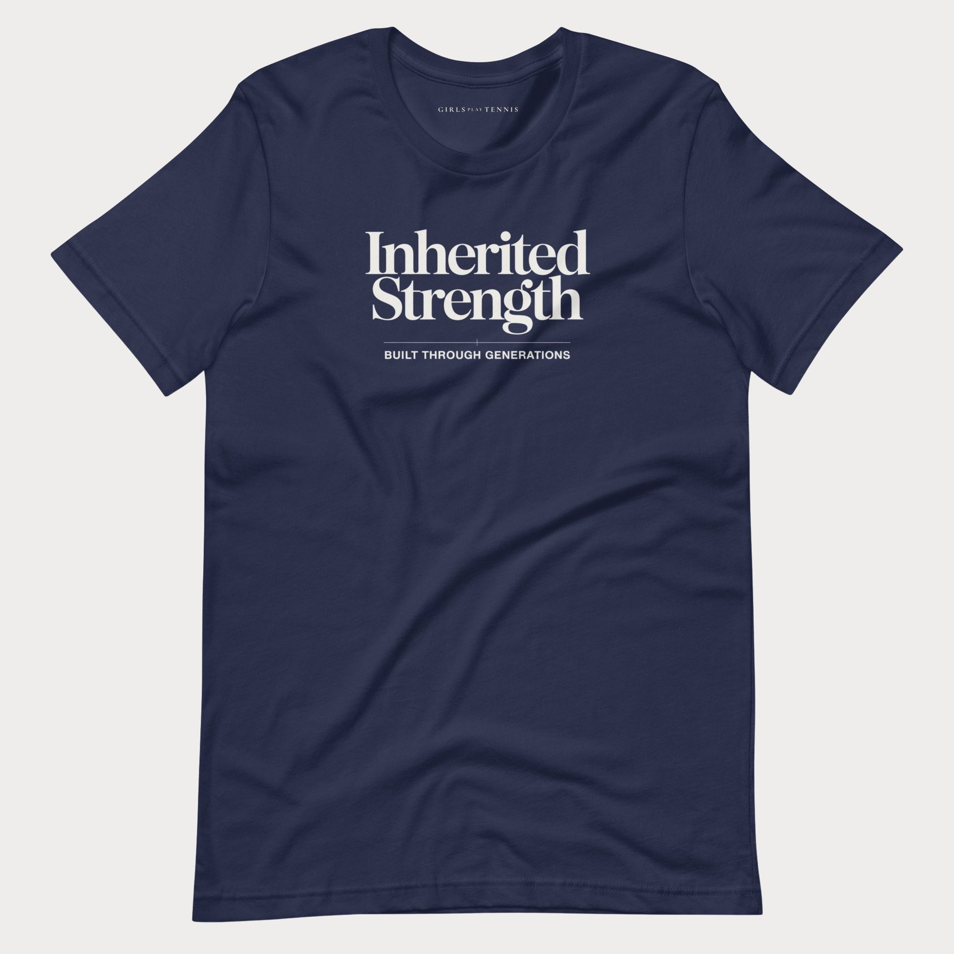 A navy blue short-sleeve crewneck women's tennis t-shirt with white printed text reading 'Inherited Strength' and 'BUILT THROUGH GENERATIONS' on the chest, displayed flat against a light gray background.