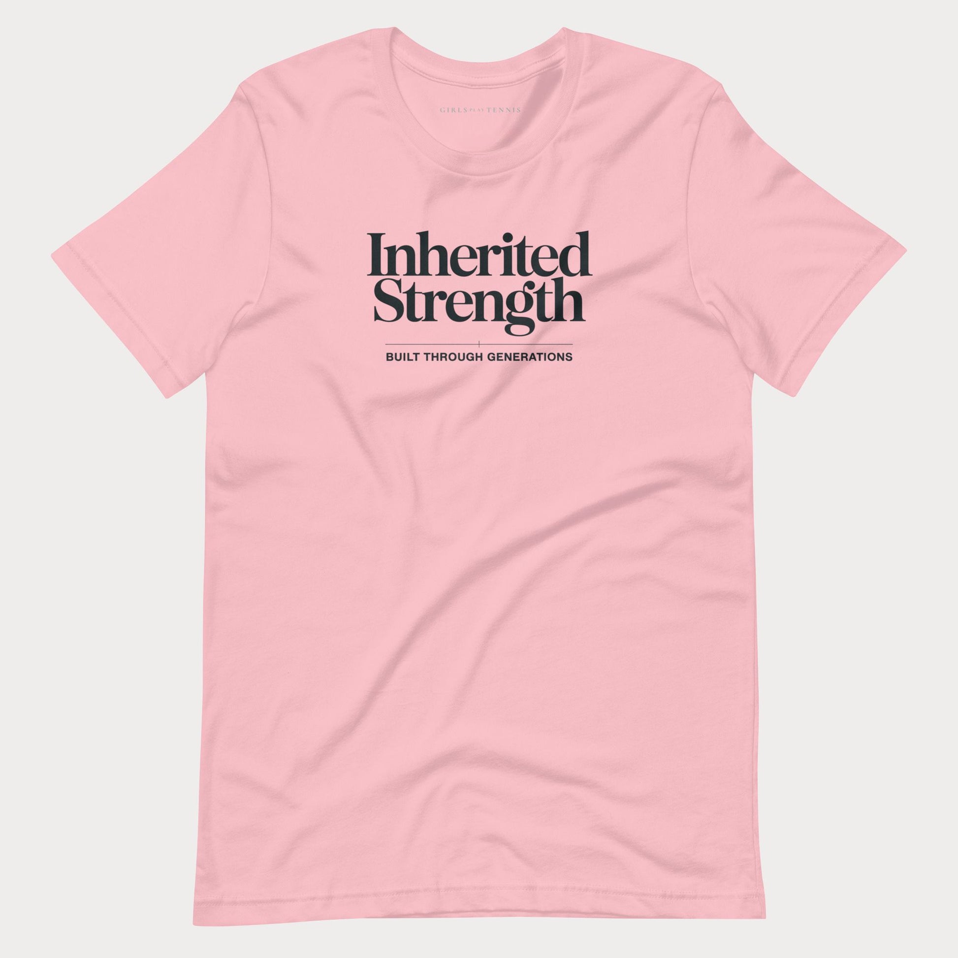 A light pink short-sleeve crewneck t-shirt with black text on the chest reading 'Inherited Strength' and 'BUILT THROUGH GENERATIONS' underneath, displayed on a light gray background.