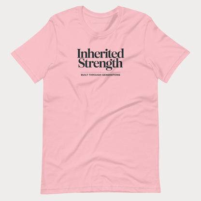 A light pink short-sleeve crewneck t-shirt with black text on the chest reading 'Inherited Strength' and 'BUILT THROUGH GENERATIONS' underneath, displayed on a light gray background.