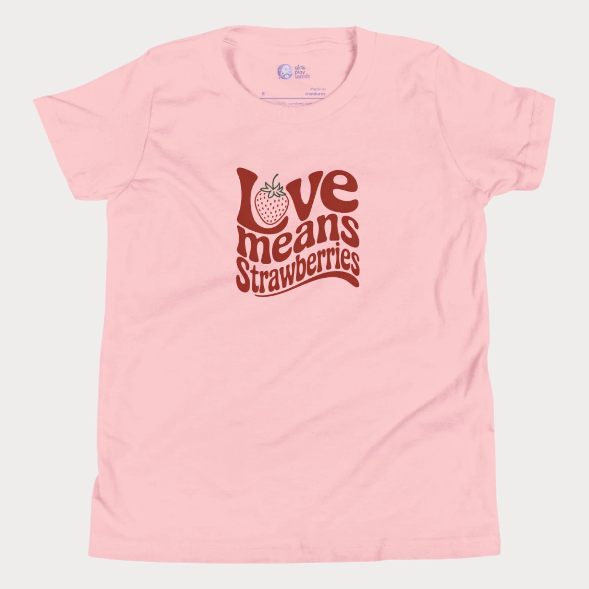 Pink girls’ tennis T-shirt with retro red “Love Means Strawberries” slogan and cute illustrated strawberry. 