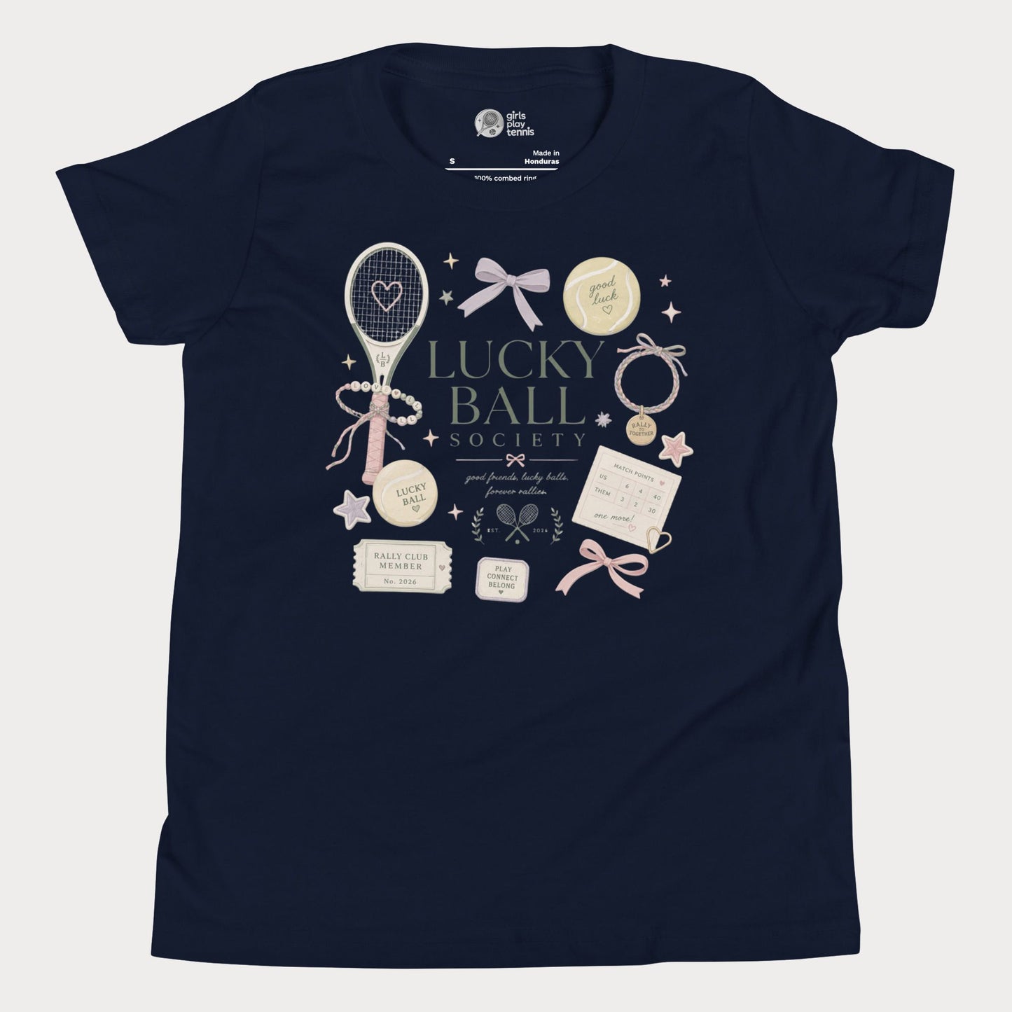 Navy girls tennis tee featuring lucky ball society artwork with bows, bracelets, and vintage tennis lifestyle details