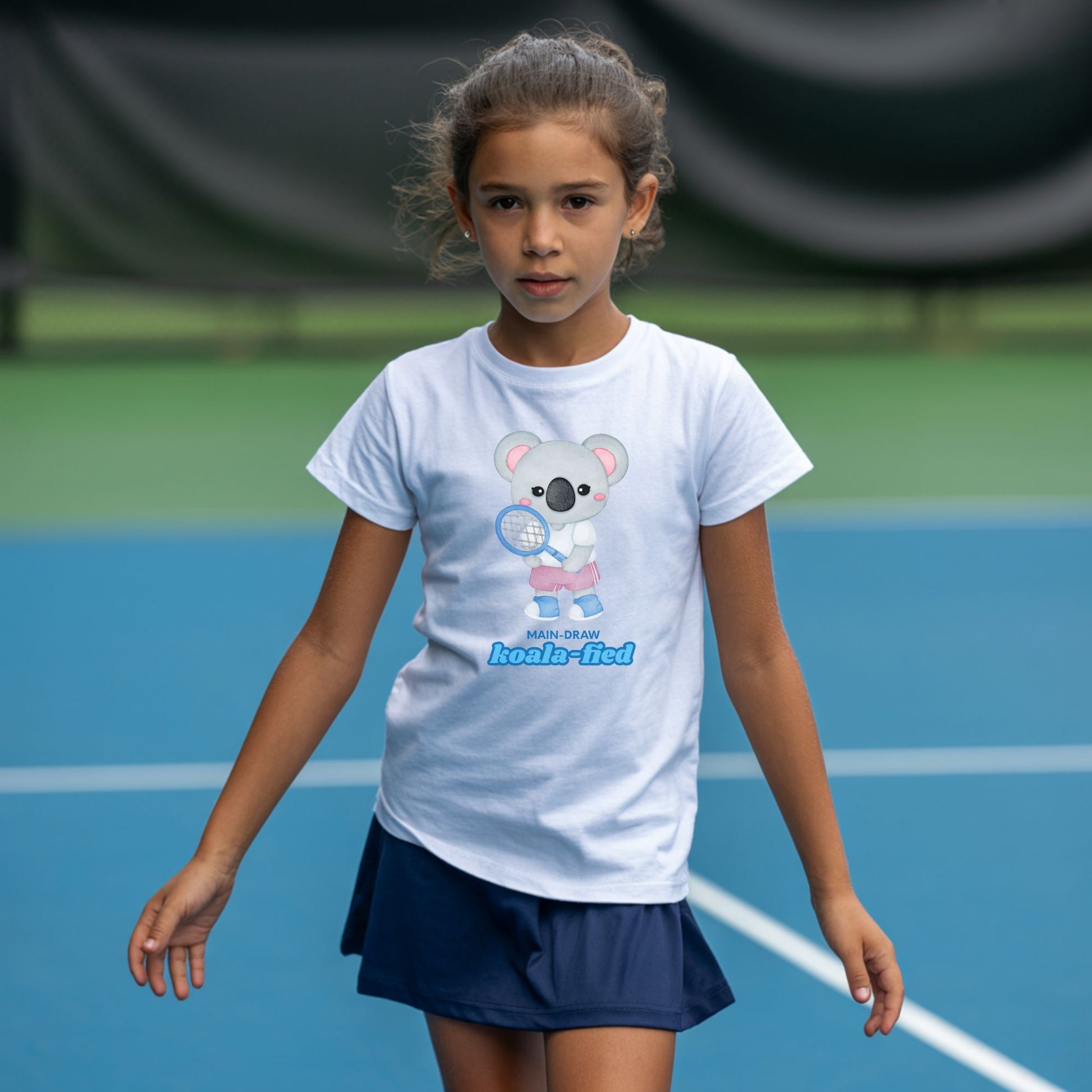 Young girl wearing a main-Draw Koala-fied white tennis t-shirt with cute koala character for girls.