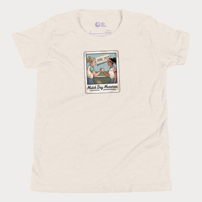 Polaroid-style illustration of two girls shaking hands on a tennis court with ‘June 1973’ and text reading Match Day Memories on a girls tennis t-shirt
