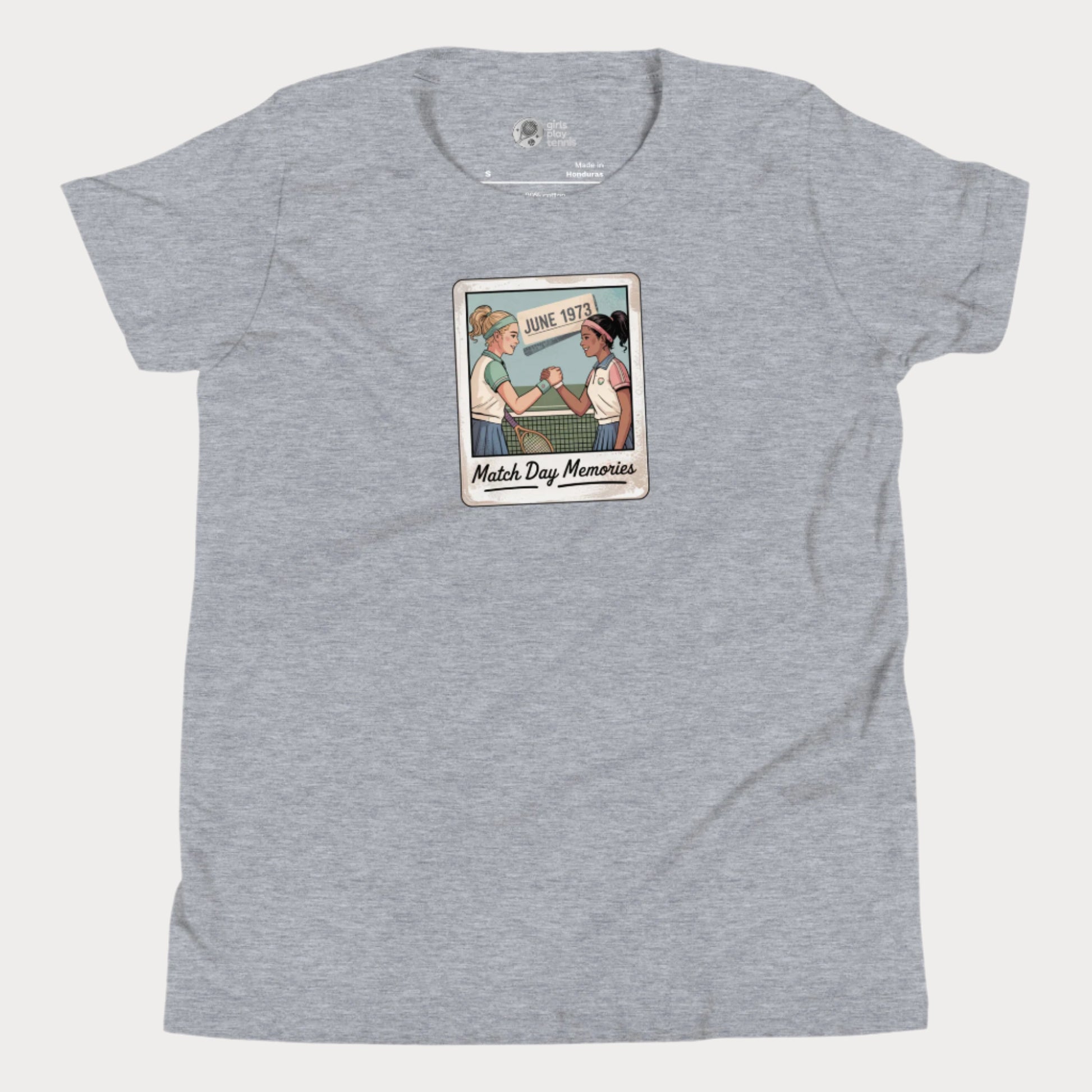 Polaroid-style illustration of two girls shaking hands on a tennis court with ‘June 1973’ and text reading Match Day Memories on a girls tennis t-shirt