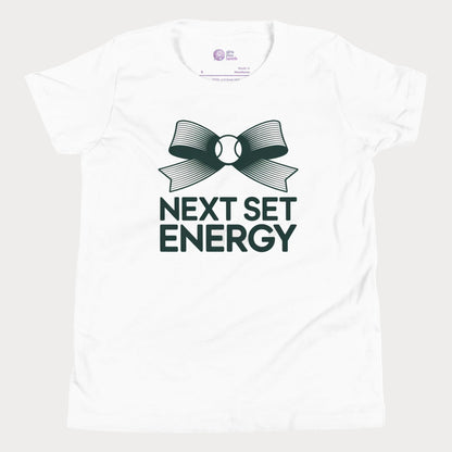 Next Set Energy tennis tee in white with green bow and bold typography design for girls and women