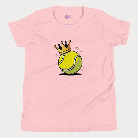 A pink girls’ tennis t-shirt featuring a bold yellow tennis ball with a golden crown perched on top. This playful design celebrates young girls who rule the court with power and personality.