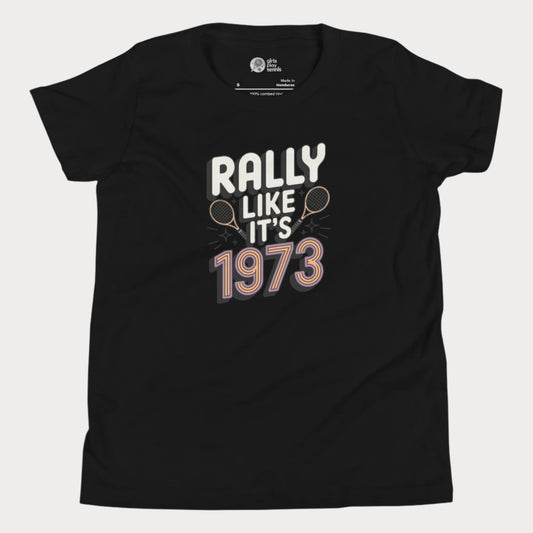 Black girls tennis t-shirt with retro slogan ‘Rally Like It’s 1973’ and crossed tennis rackets