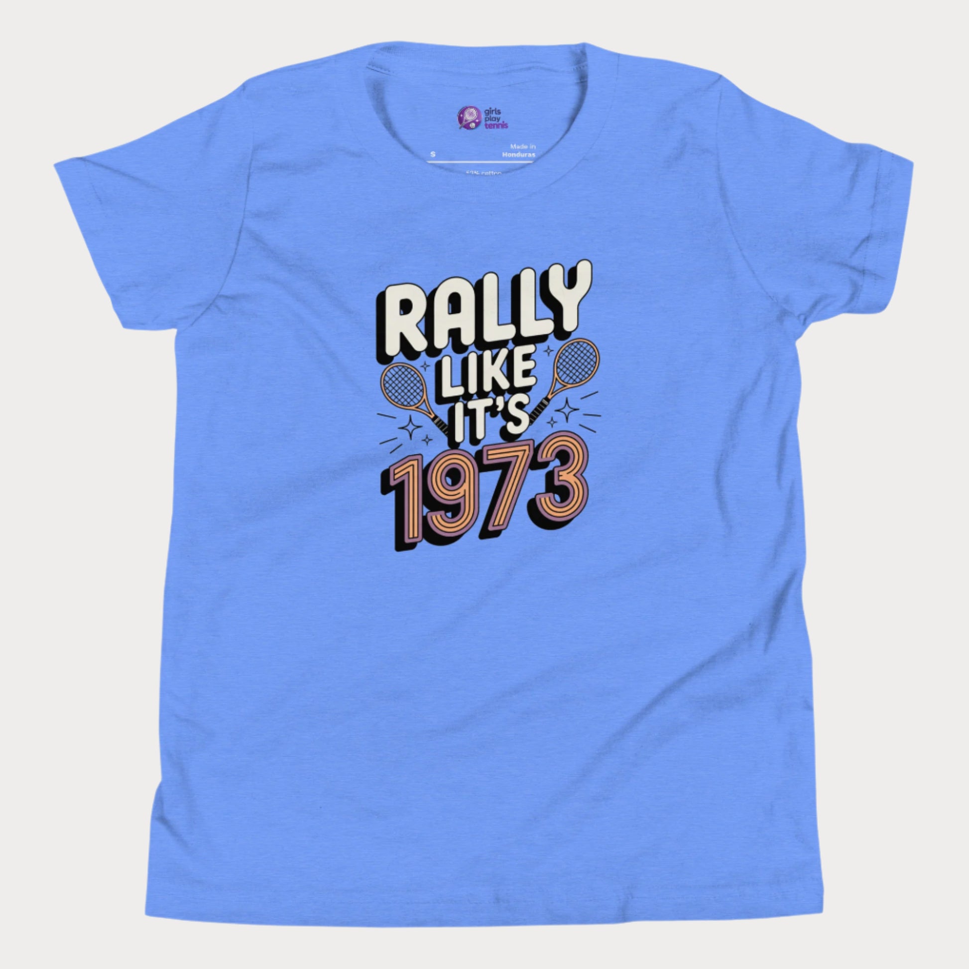 Blue girls tennis t-shirt with retro slogan ‘Rally Like It’s 1973’ and crossed tennis rackets
