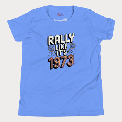Blue girls tennis t-shirt with retro slogan ‘Rally Like It’s 1973’ and crossed tennis rackets