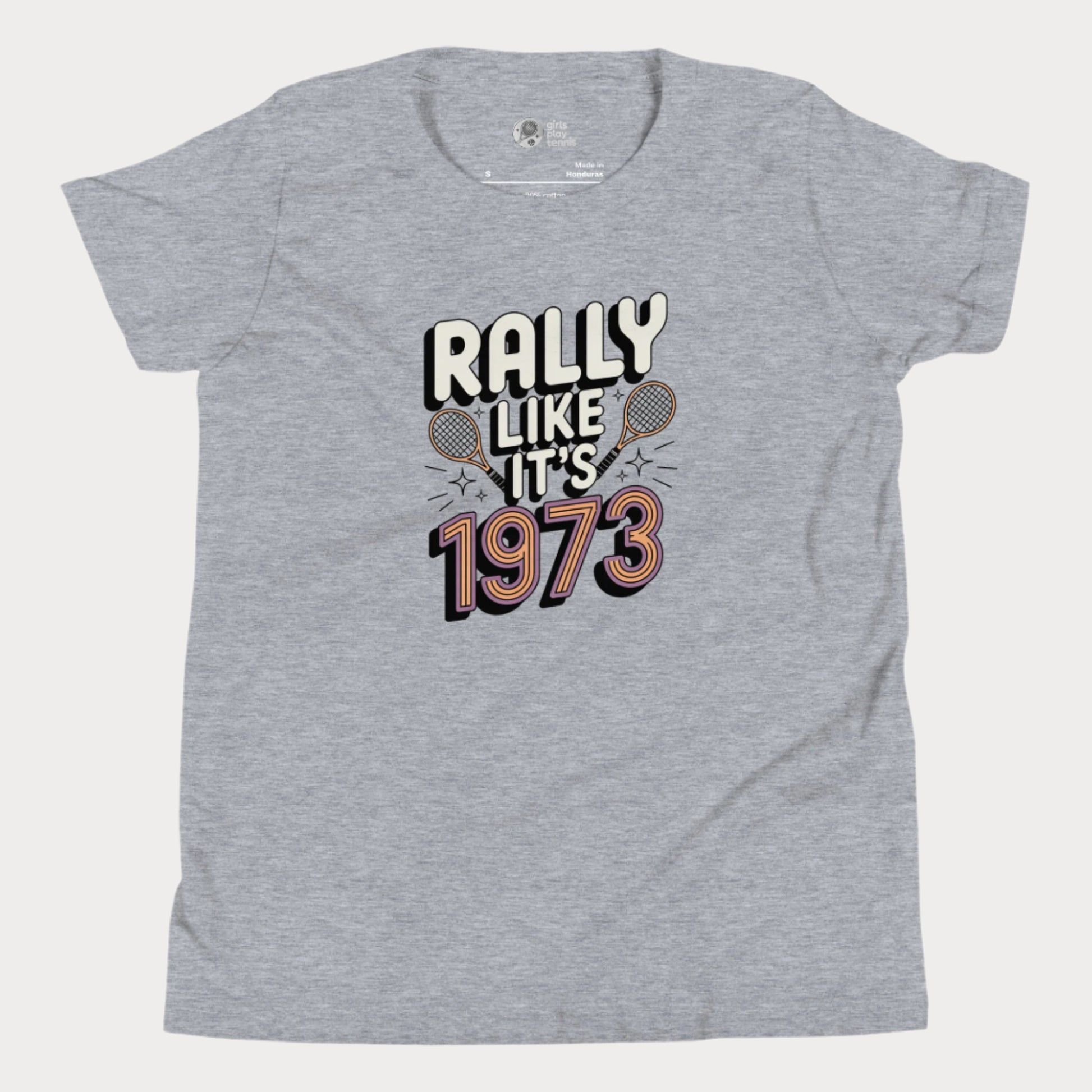 Grey girls tennis t-shirt with retro slogan ‘Rally Like It’s 1973’ and crossed tennis rackets