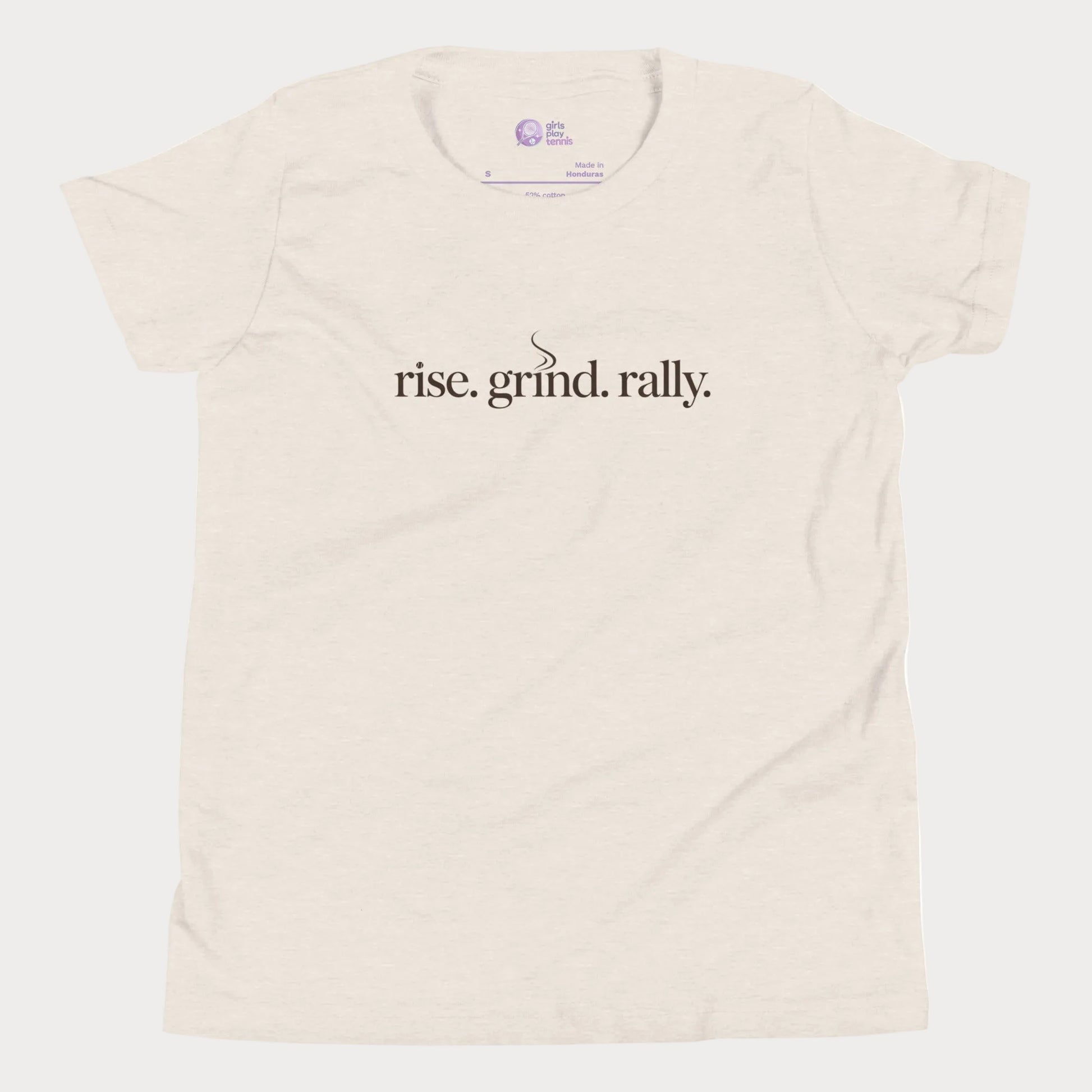 Beige tennis t-shirt with Rise Grind Rally slogan across the chest – Girls Play Tennis apparel.