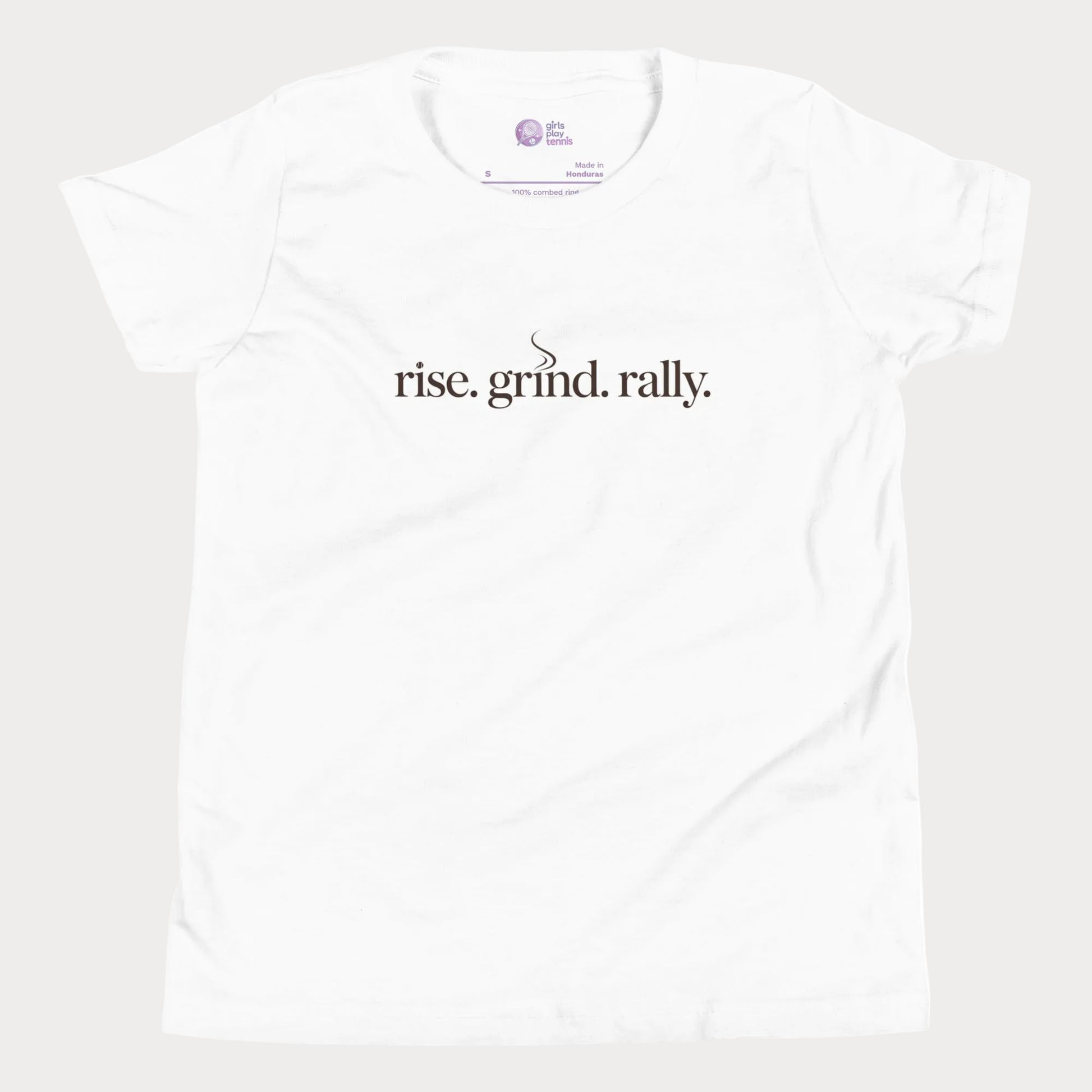 White tennis t-shirt with Rise Grind Rally slogan across the chest – Girls Play Tennis apparel.