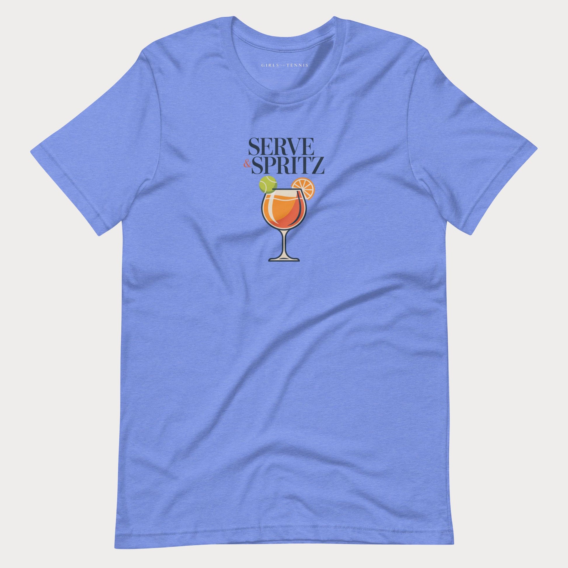 A blue-colored short-sleeve tennis lifestyle t-shirt with a graphic on the chest that reads 'SERVE & SPRITZ' above an illustration of a cocktail with a tennis ball and orange slice.