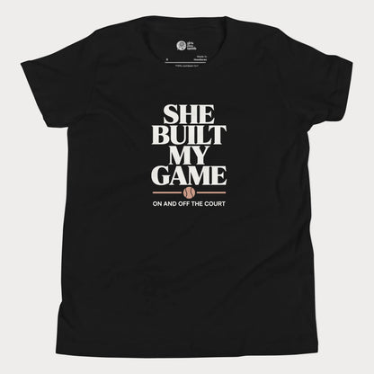 She Built My Game tennis t-shirt in black with white typography and tennis graphic for girls and women