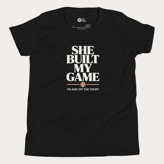 She Built My Game tennis t-shirt in black with white typography and tennis graphic for girls and women
