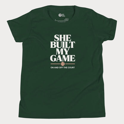 She Built My Game tennis t-shirt in black with white typography and tennis graphic for girls and women.