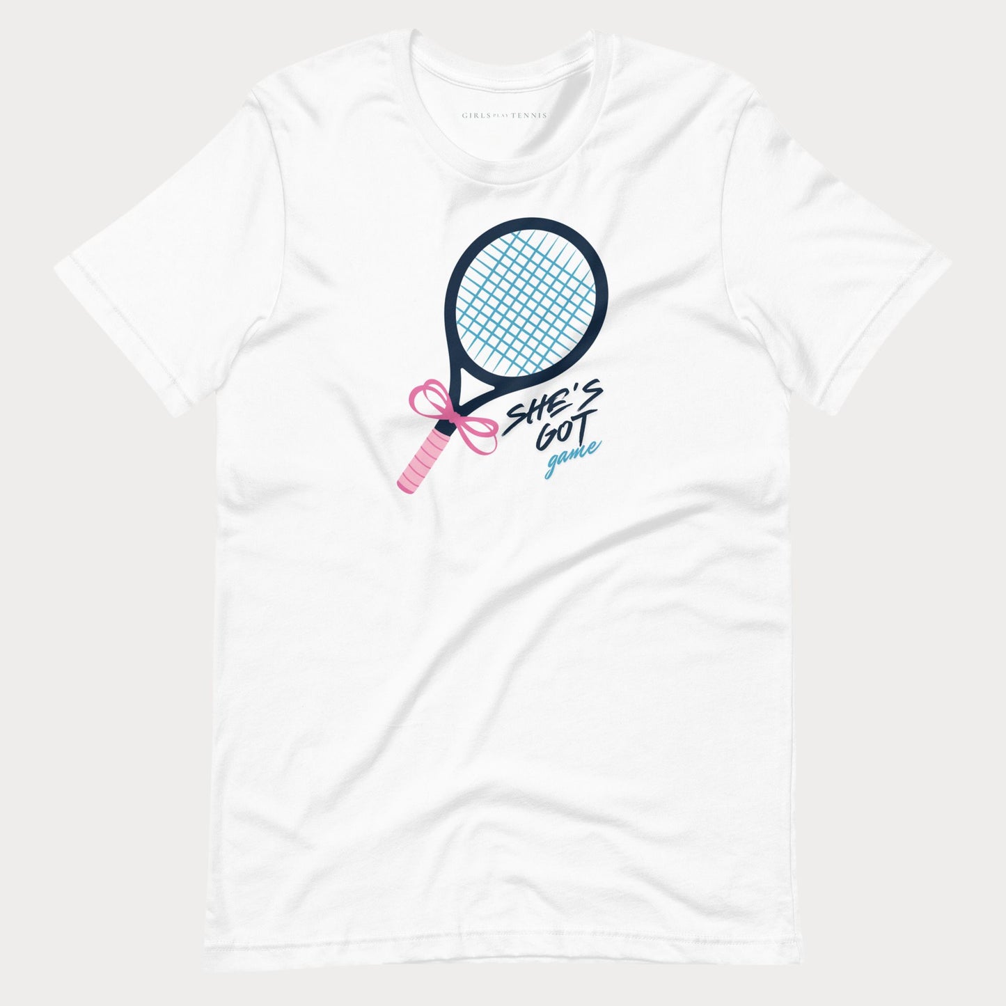 A white short-sleeve crewneck t-shirt featuring a graphic of a tennis racket with a pink bow and the text 'SHE'S GOT game' in black and light blue script.