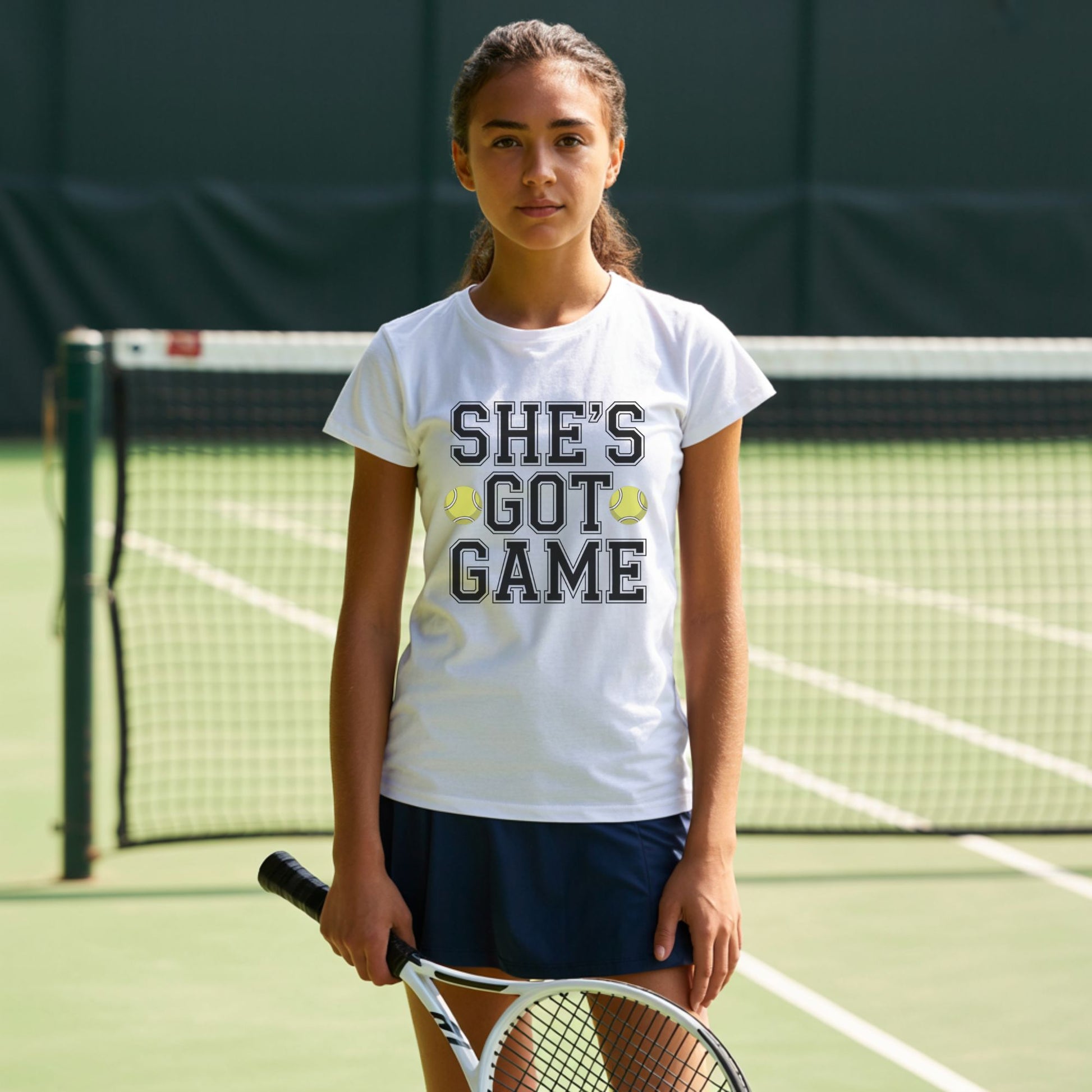 Teenage girls wearing a white t-shirt with empowering slogan “She’s Got Game” and tennis ball accents.