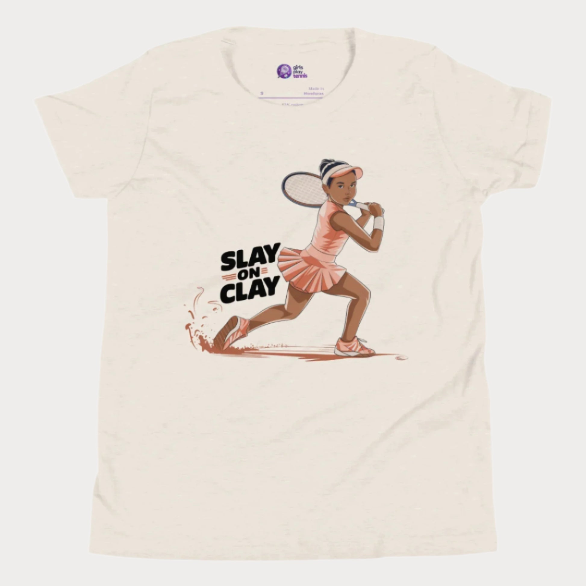 Beige heather tennis T-shirt featuring an illustrated young girl in a fierce backhand stance, sliding on a clay court with the phrase "Slay on Clay."