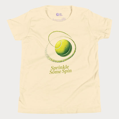 Butter yellow girls tennis t-shirt with a spinning yellow tennis ball and the phrase “Sprinkle Some Spin” in bold yellow text