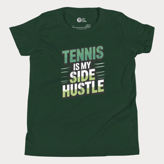 Girls tennis t-shirt with 'Tennis Is My Side Hustle' slogan, celebrating hustle and grit during hard court season.