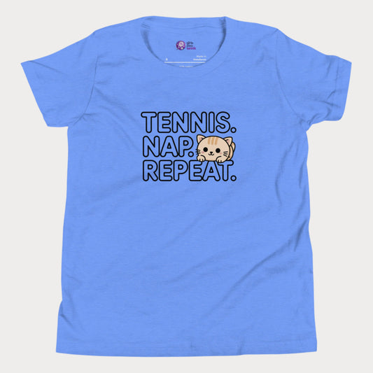 Blue kids tennis t-shirt with “Tennis. Nap. Repeat.” text and a cute cartoon cat illustration, part of the Girls Play Tennis apparel line.