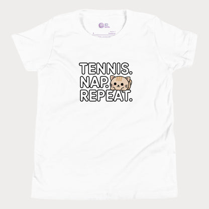 White kids tennis t-shirt with “Tennis. Nap. Repeat.” text and a cute cartoon cat illustration, part of the Girls Play Tennis apparel line.