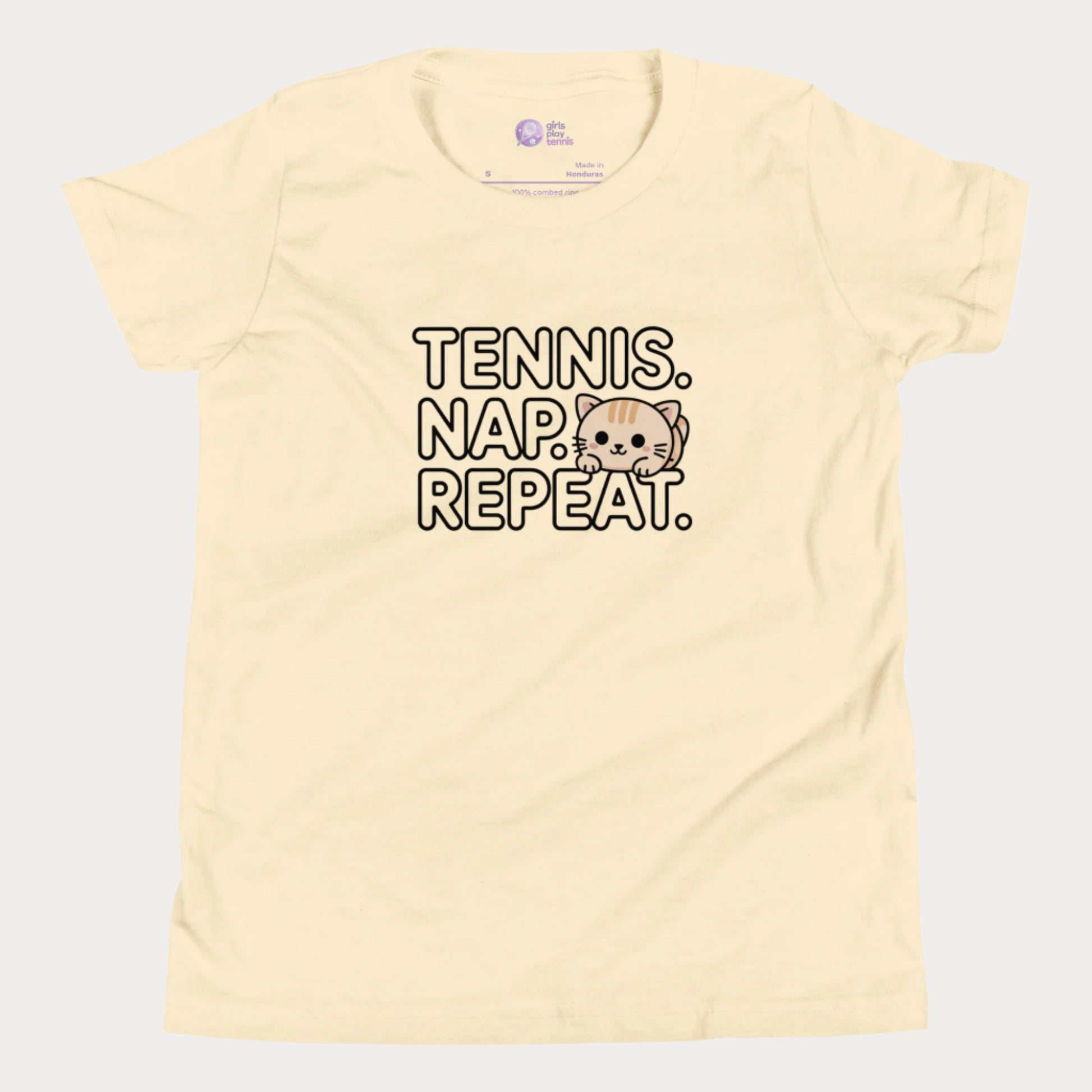 Cream kids tennis t-shirt with “Tennis. Nap. Repeat.” text and a cute cartoon cat illustration, part of the Girls Play Tennis apparel line.