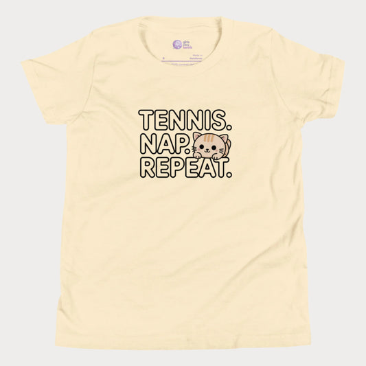 Cream kids tennis t-shirt with “Tennis. Nap. Repeat.” text and a cute cartoon cat illustration, part of the Girls Play Tennis apparel line.