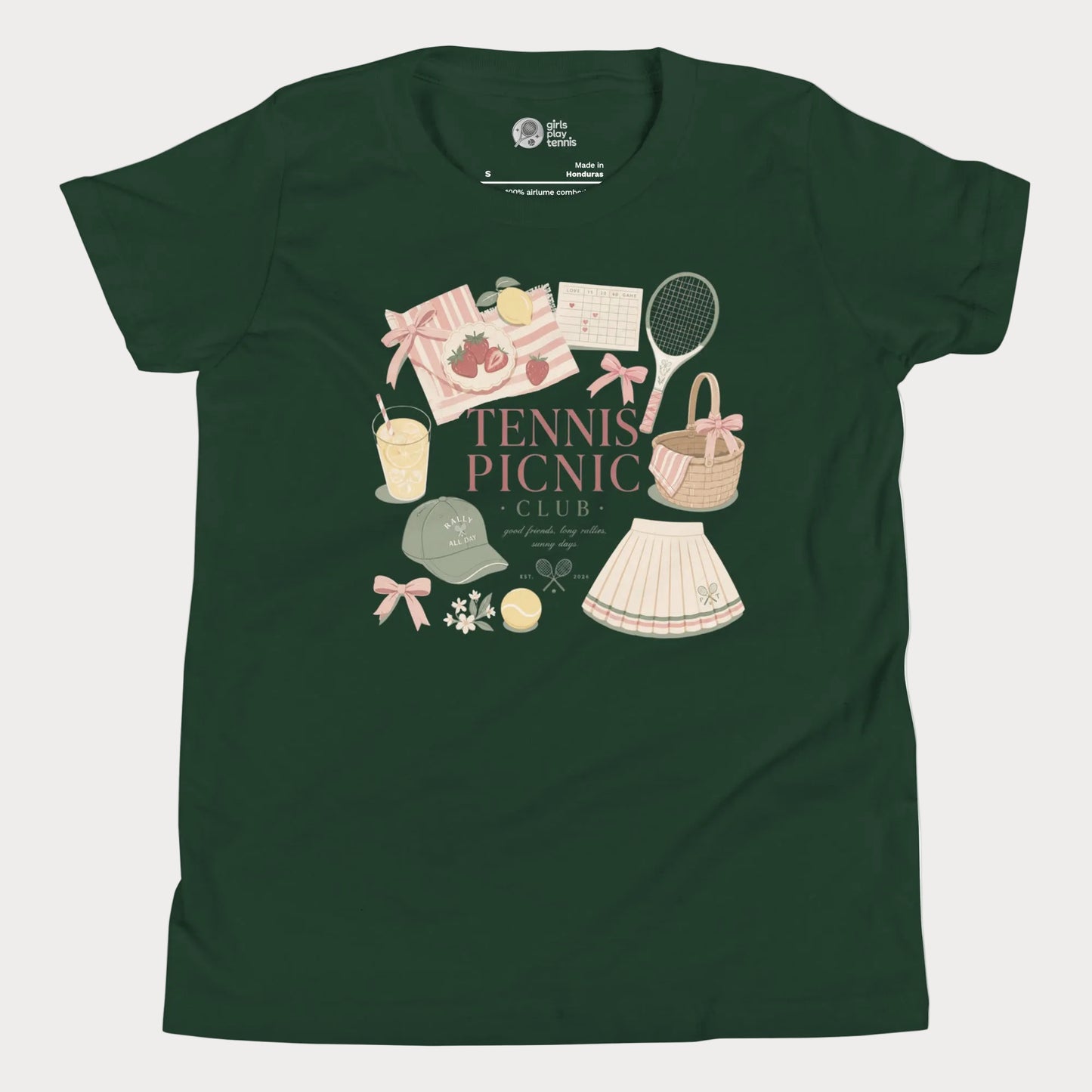 Girls tennis tee featuring picnic-inspired tennis lifestyle artwork with strawberries, lemonade, bows, and pleated skirt details