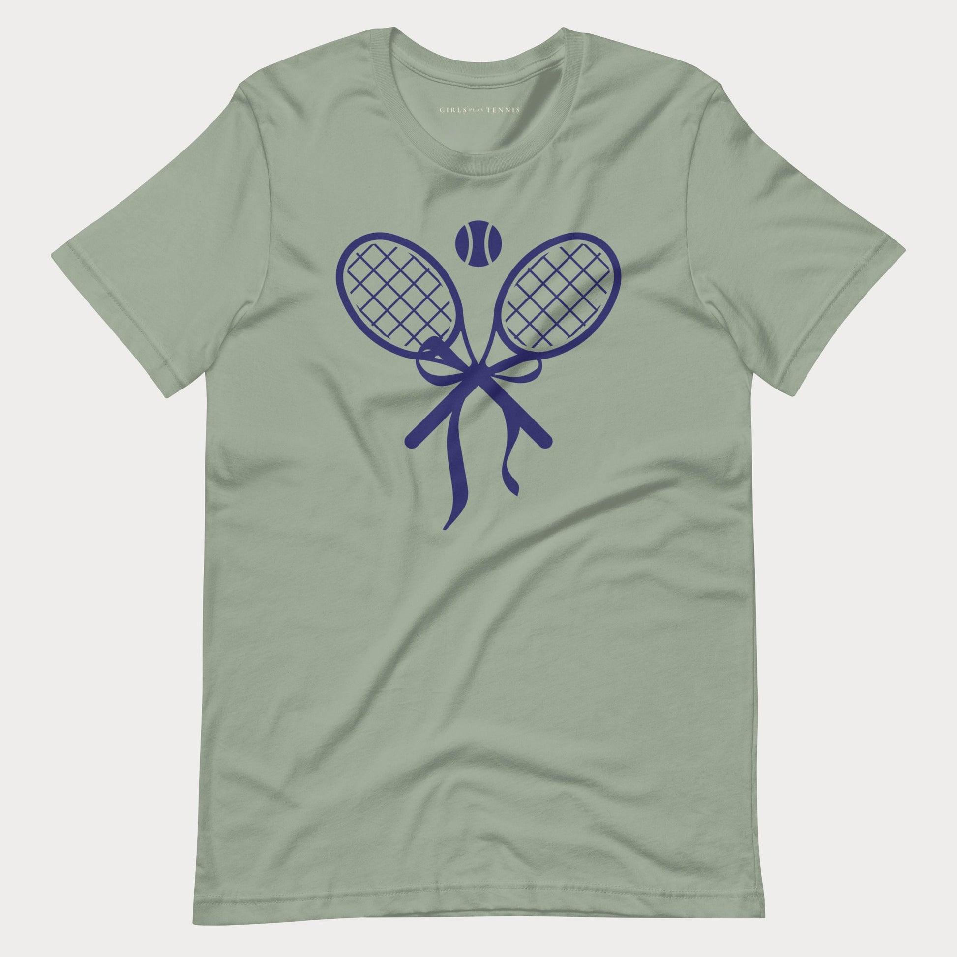A sage green short-sleeve crewneck tennis t-shirt featuring a dark blue graphic of two crossed tennis rackets tied with a bow, with a tennis ball above them.
